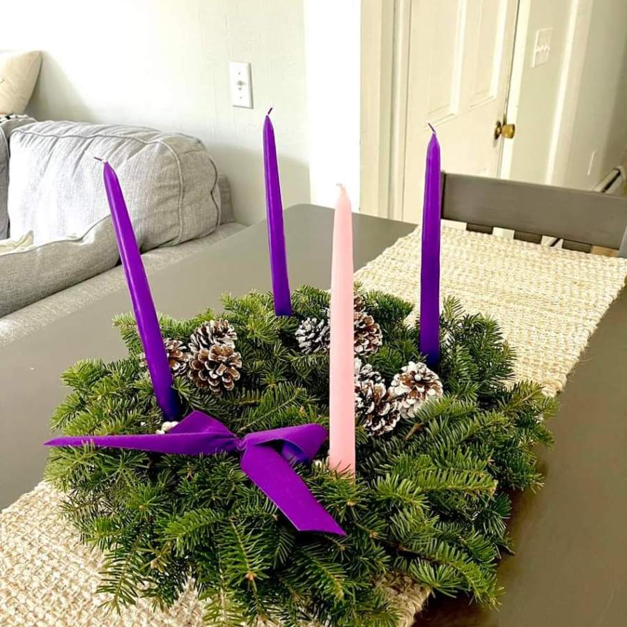 a bed with a purple flower