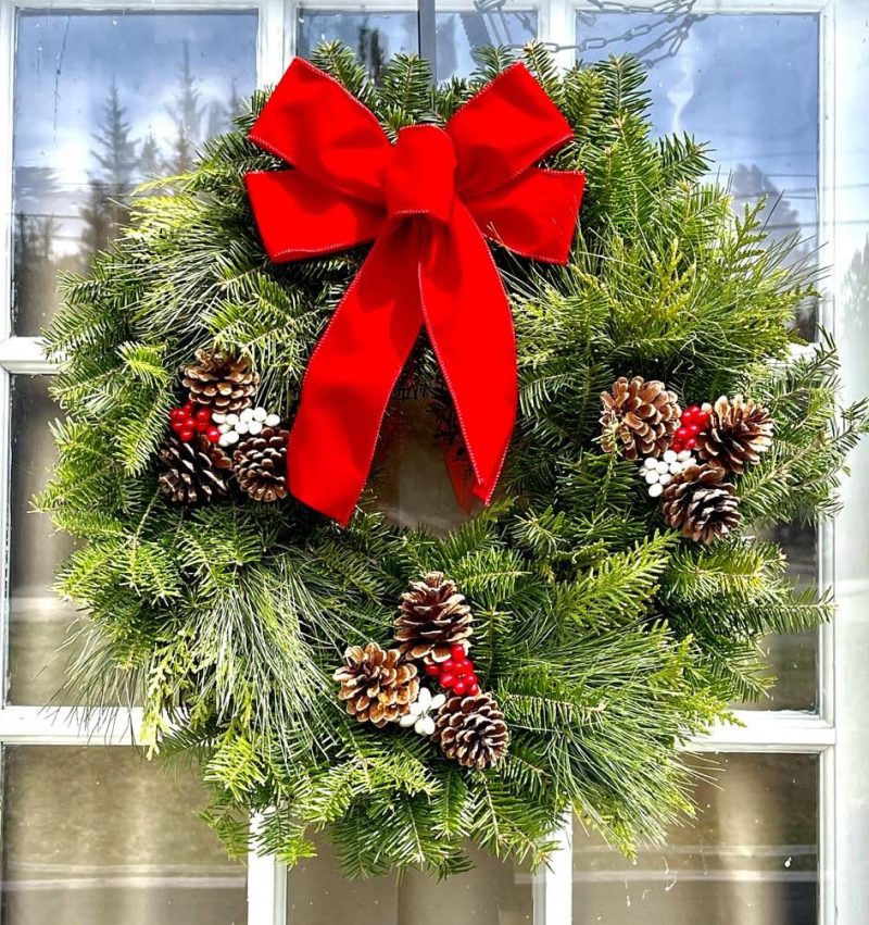 a vase of flowers sits in front of a window
